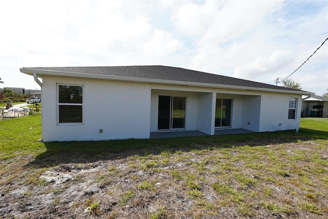 rear view of property with a yard