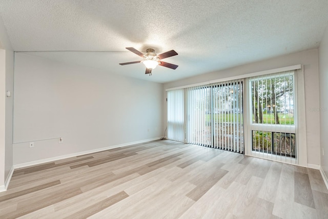 spare room featuring light hardwood / wood-style floors, a textured ceiling, and ceiling fan