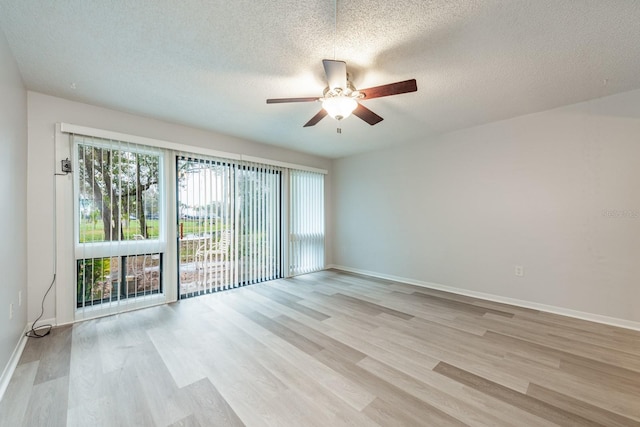 spare room with ceiling fan, a healthy amount of sunlight, and light wood-type flooring