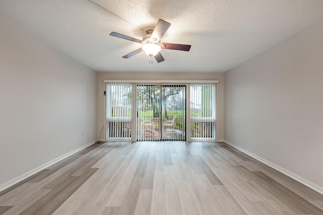 empty room with a textured ceiling, ceiling fan, and light wood-type flooring