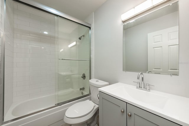 full bathroom with vanity, toilet, and enclosed tub / shower combo