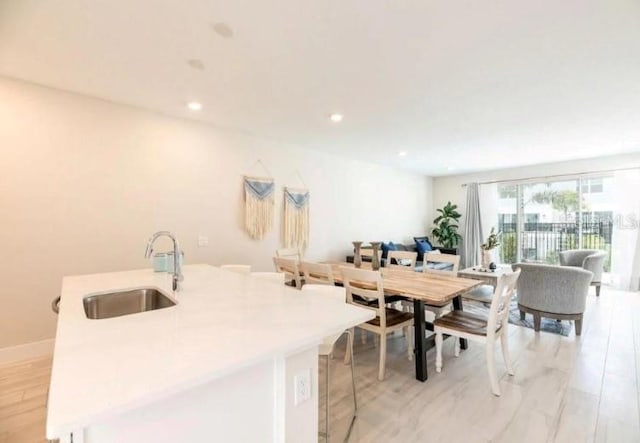 dining space featuring light hardwood / wood-style floors and sink