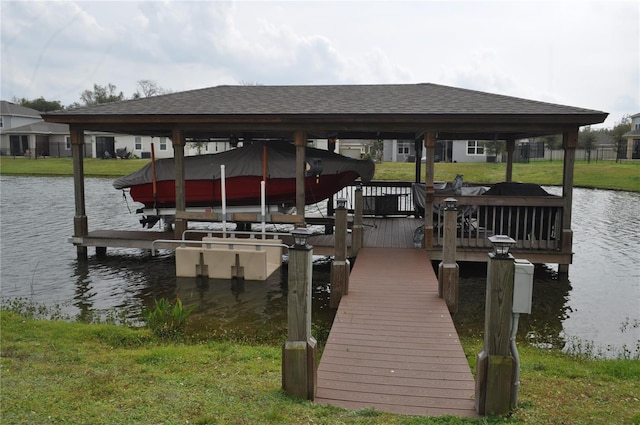 view of dock featuring a water view and a yard