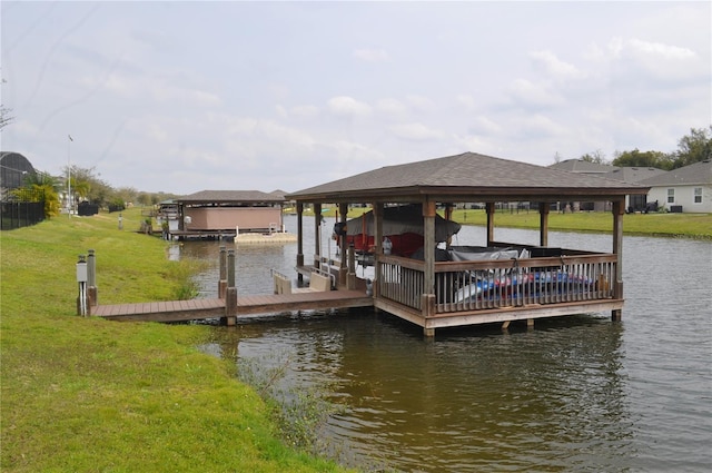 dock area featuring a yard and a water view