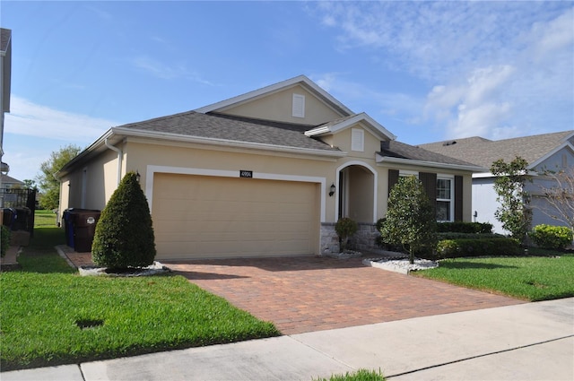 view of front of home featuring a garage and a front lawn