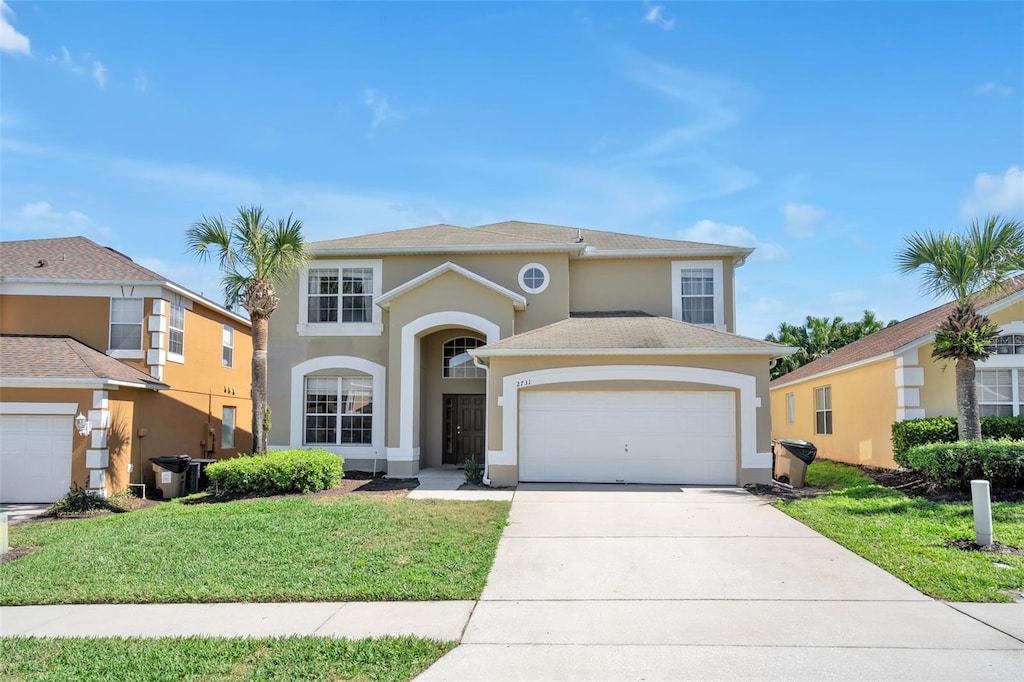 view of front of house featuring a front yard and a garage