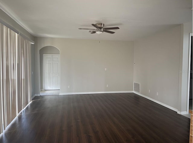 spare room with ceiling fan and dark hardwood / wood-style flooring