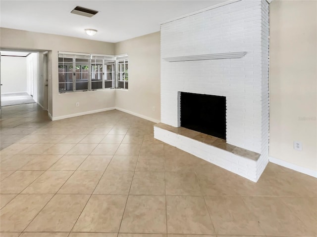 unfurnished living room featuring light tile patterned floors and a brick fireplace