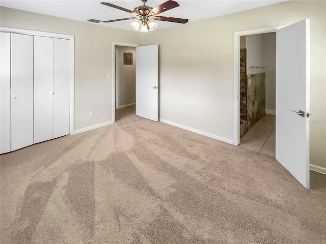 unfurnished bedroom with ceiling fan, a closet, and light colored carpet