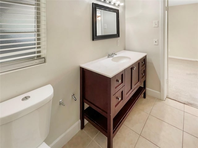 bathroom featuring tile patterned flooring, vanity, and toilet