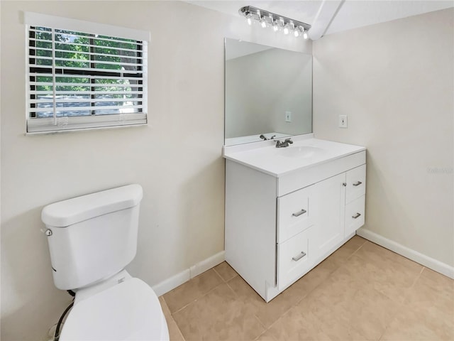 bathroom featuring tile patterned floors, vanity, and toilet