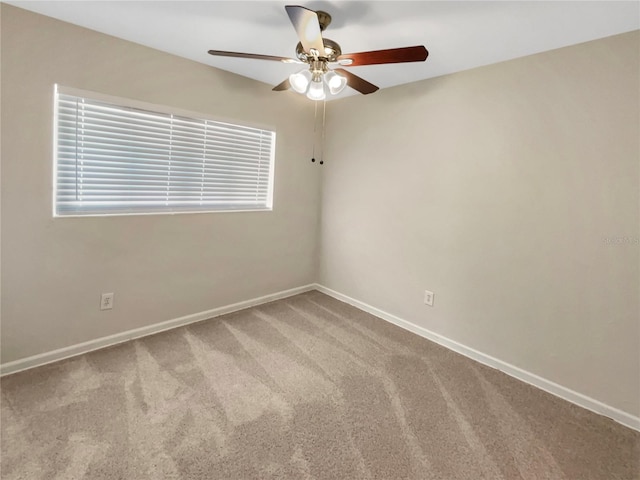 spare room featuring carpet and ceiling fan