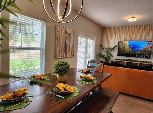 dining area with an inviting chandelier and hardwood / wood-style flooring