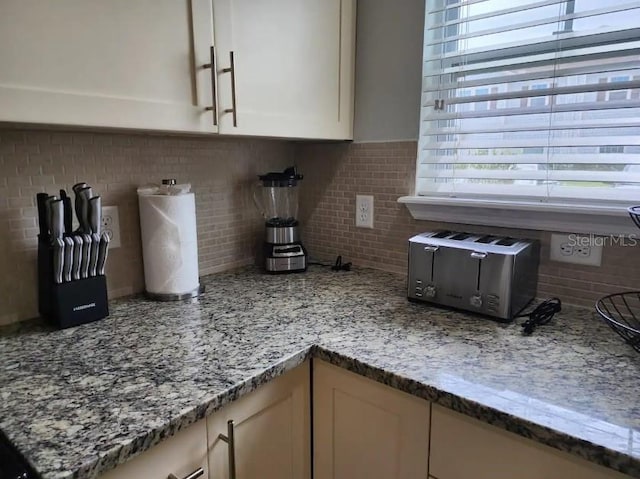 interior details featuring tasteful backsplash and light stone countertops