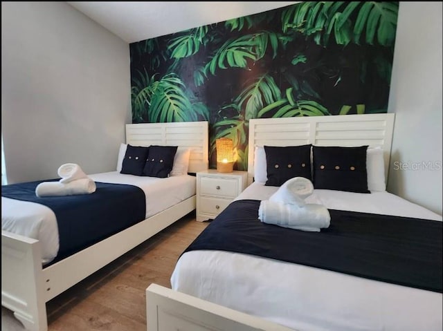 bedroom with dark wood-type flooring