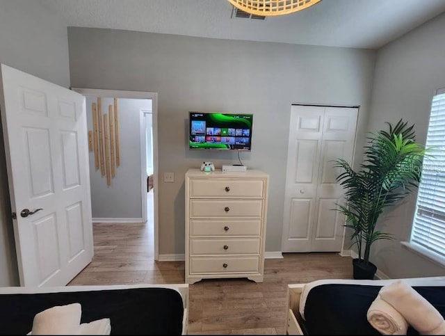 bedroom with a closet and hardwood / wood-style floors