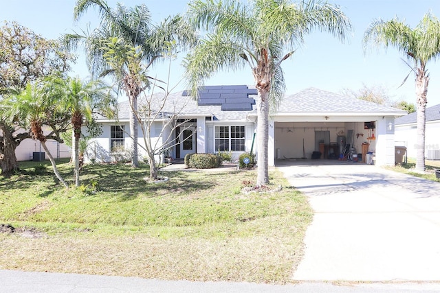 view of front of property featuring a front yard and a garage