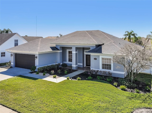 view of front of home with a front lawn and a garage