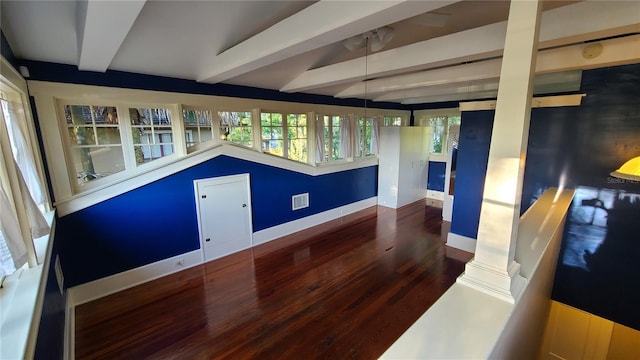 interior space featuring beam ceiling and dark wood-type flooring