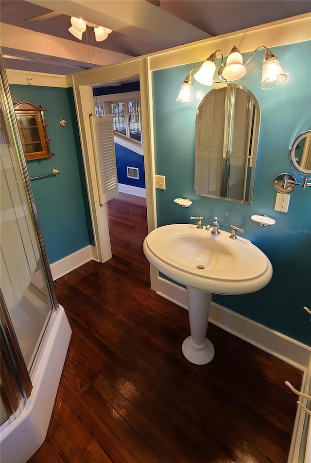 bathroom with hardwood / wood-style flooring