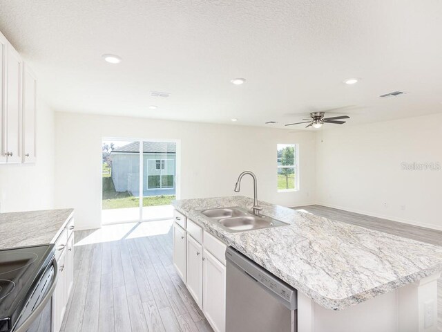 kitchen with white cabinets, stainless steel dishwasher, a kitchen island with sink, and sink