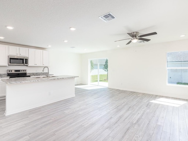 kitchen with ceiling fan, sink, stainless steel appliances, light hardwood / wood-style flooring, and white cabinets