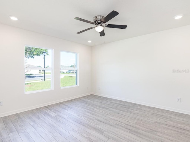 empty room featuring ceiling fan and light wood-type flooring