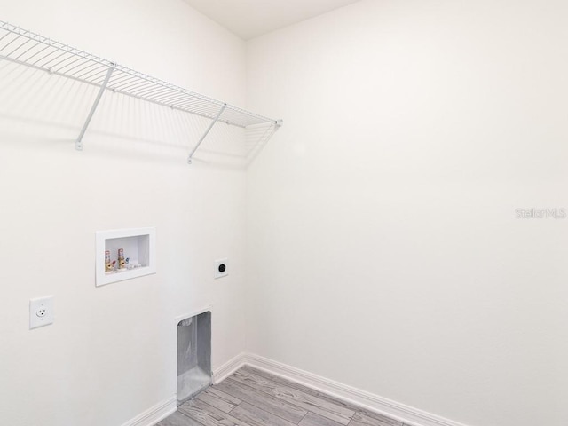 laundry room featuring electric dryer hookup, hookup for a washing machine, and light wood-type flooring