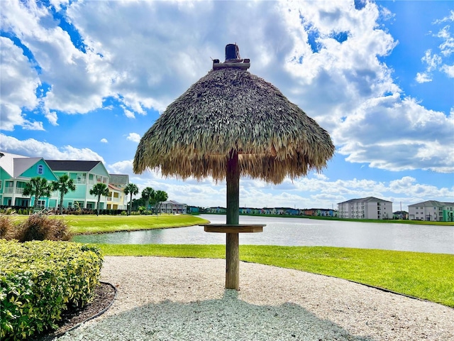 view of home's community featuring a yard and a water view