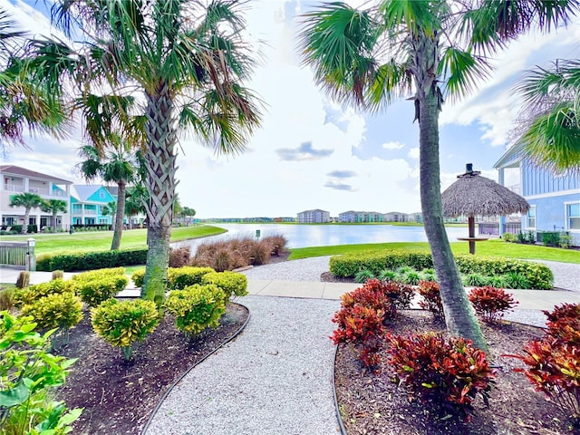 view of nearby features featuring a water view and a lawn