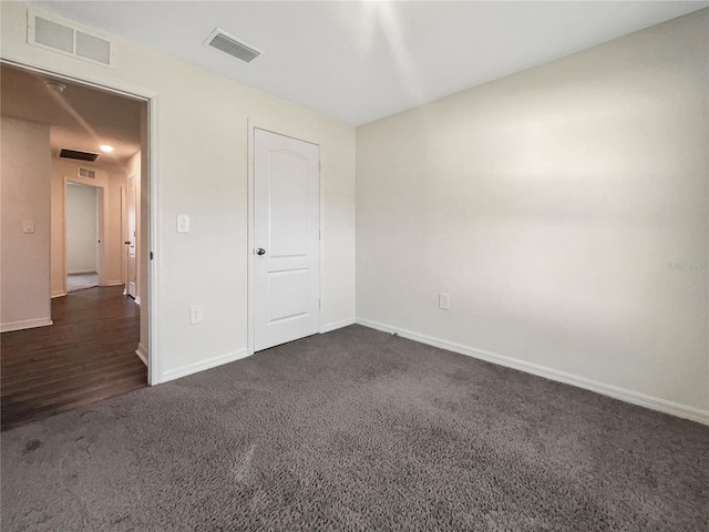 unfurnished bedroom with dark hardwood / wood-style flooring