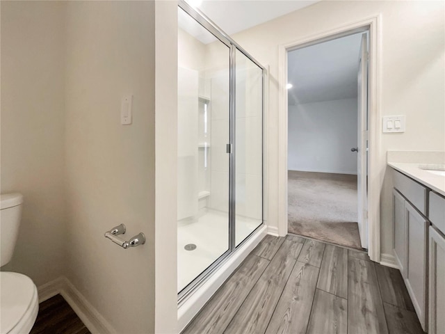 bathroom with an enclosed shower, toilet, and vanity