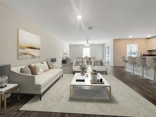 living room featuring wood-type flooring and ceiling fan