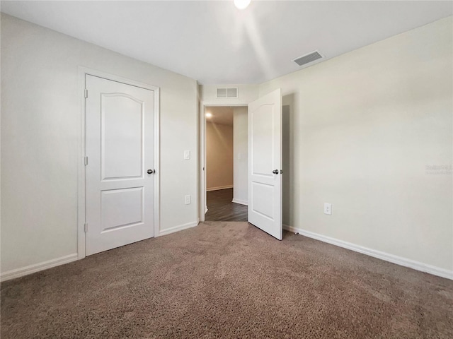 unfurnished bedroom featuring dark colored carpet