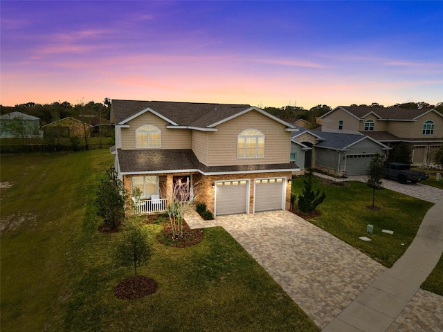 view of front of property featuring a lawn and a garage