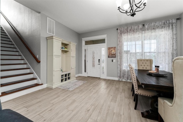 office space featuring a chandelier and light wood-type flooring