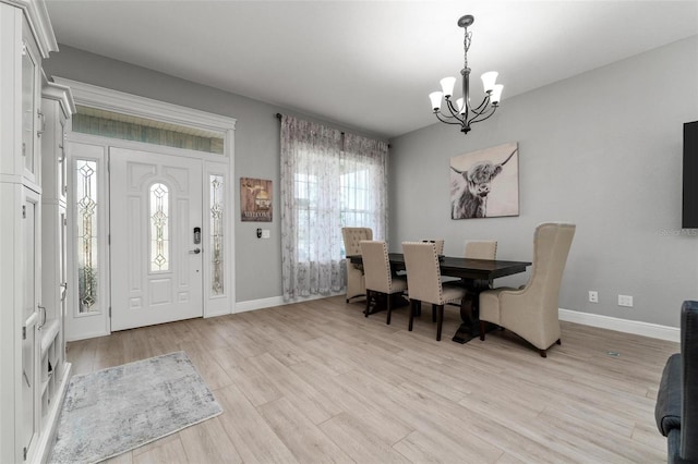 dining area featuring an inviting chandelier and light wood-type flooring