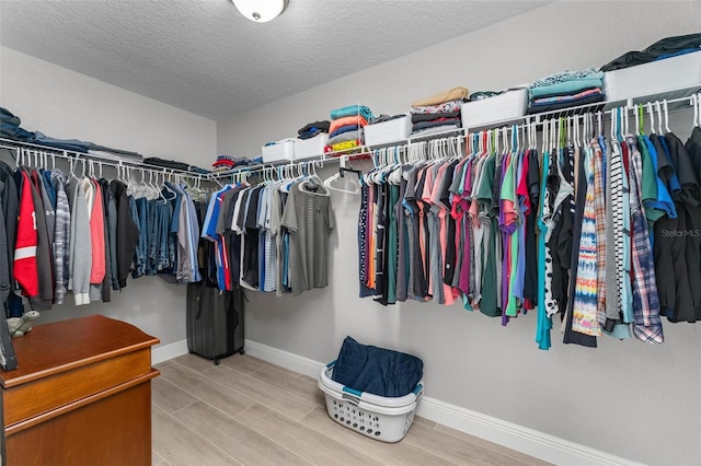 walk in closet featuring light hardwood / wood-style floors