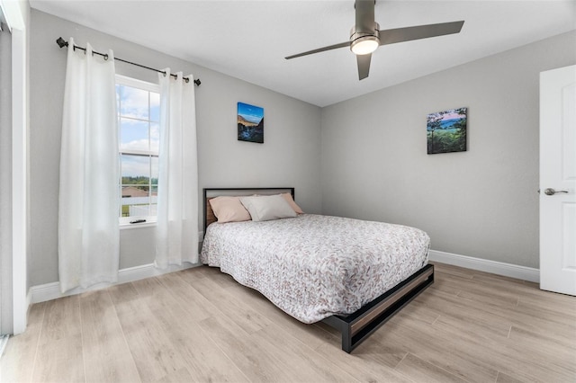 bedroom with ceiling fan and light hardwood / wood-style flooring