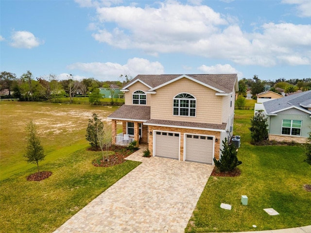 view of front of property with a front yard and a garage