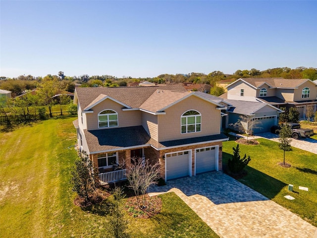 view of front of property featuring a front lawn and a garage