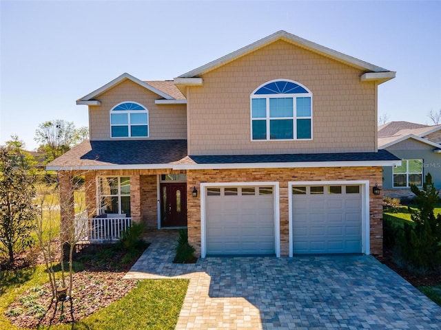 view of front of home featuring a garage and central AC unit