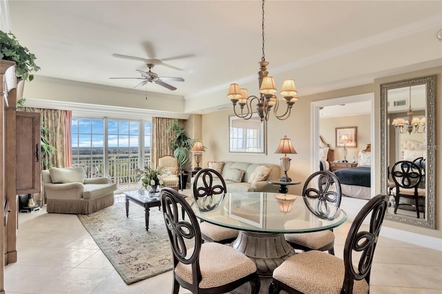 tiled dining area featuring ornamental molding and ceiling fan with notable chandelier