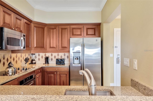 kitchen featuring light stone countertops, backsplash, sink, stainless steel appliances, and crown molding