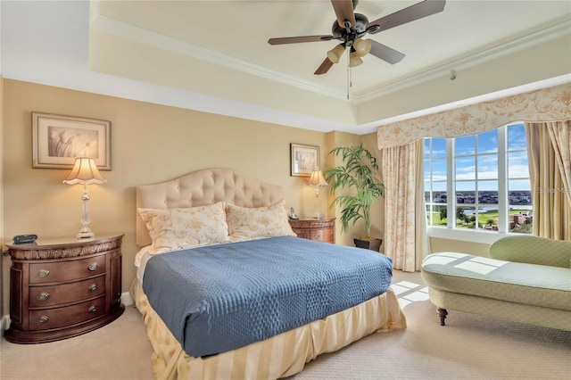 bedroom featuring light carpet, a raised ceiling, ceiling fan, and crown molding