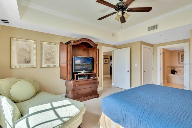 carpeted bedroom with a raised ceiling, ensuite bathroom, crown molding, and ceiling fan