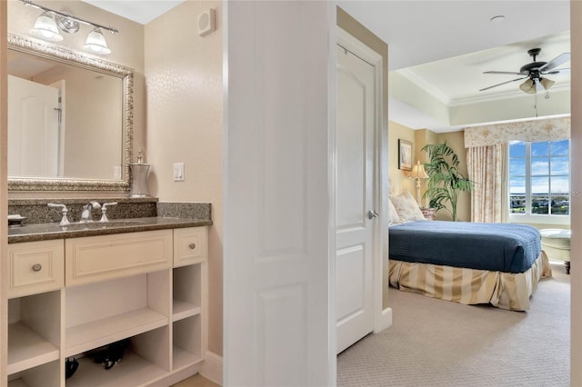 interior space featuring vanity, ceiling fan, and ornamental molding