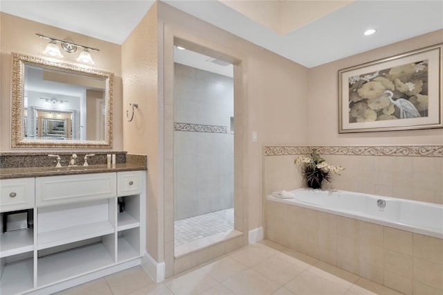 bathroom featuring tile floors, vanity, and independent shower and bath