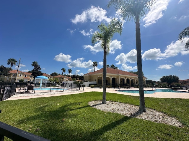 view of property's community featuring a pool and a yard