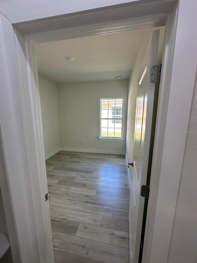 unfurnished room with light hardwood / wood-style flooring